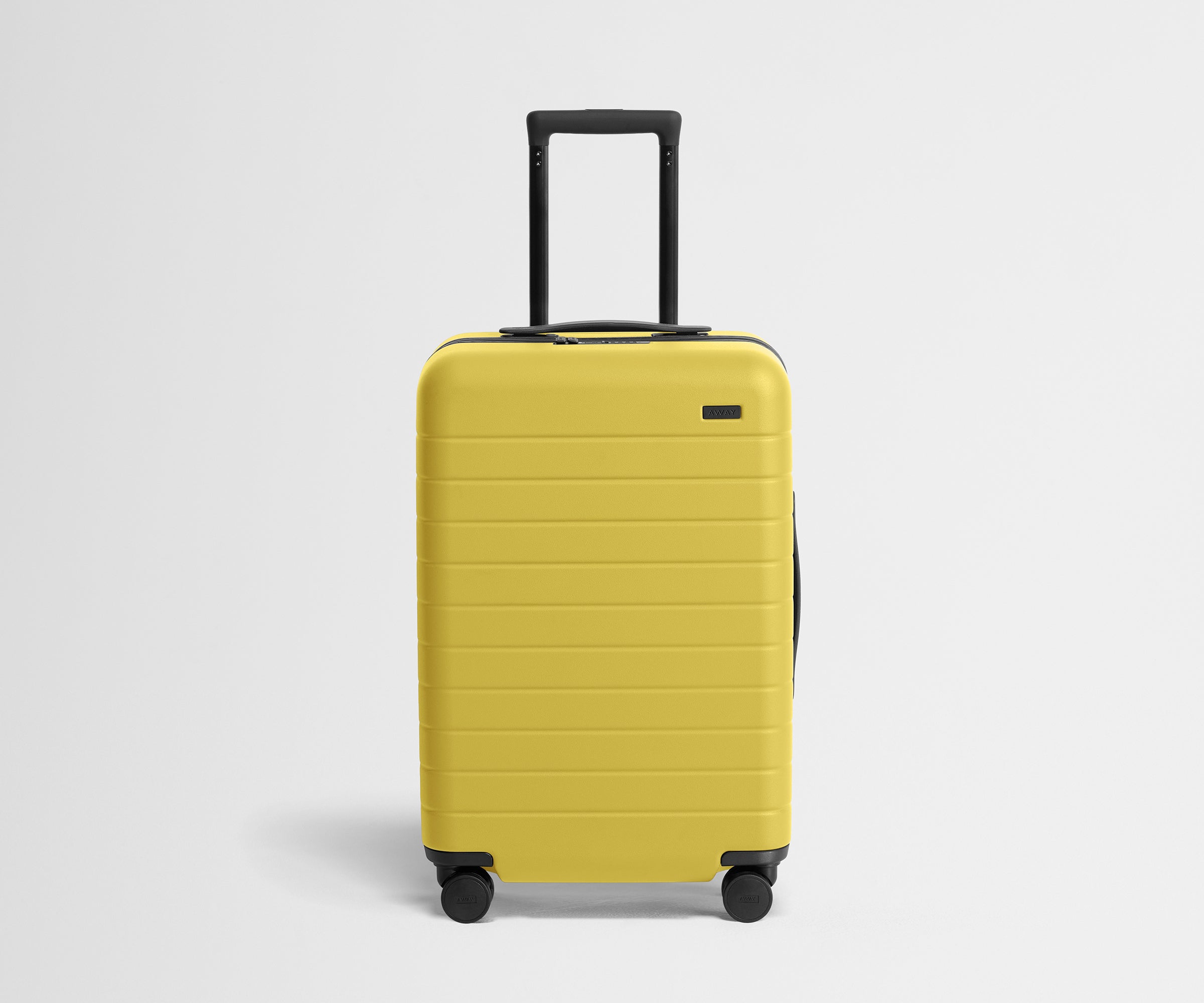 Front product view of The Bigger Carry-On suitcase in Sunshine Yellow with raised handle
