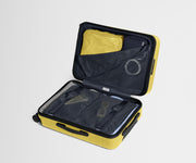 The Bigger Carry-On suitcase in Sunshine Yellow shown open on its side and packed with Away's packing organizers to show capacity and the interior compression system, designed to help you pack more in