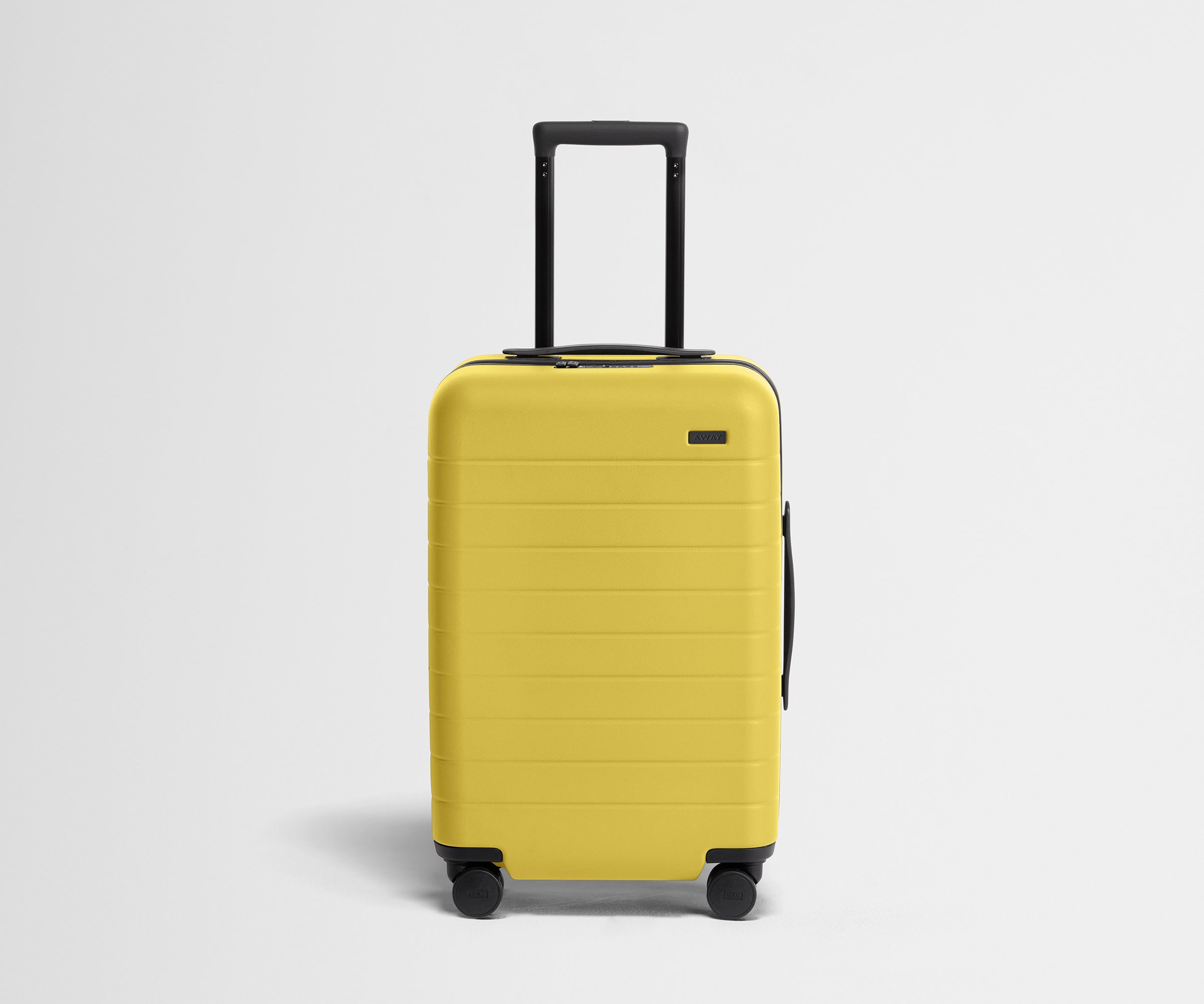 Front product view of The Carry-On suitcase in Sunshine Yellow with raised handle
