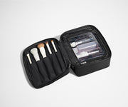 Cosmetics Bag packed with make up brushes and skincare