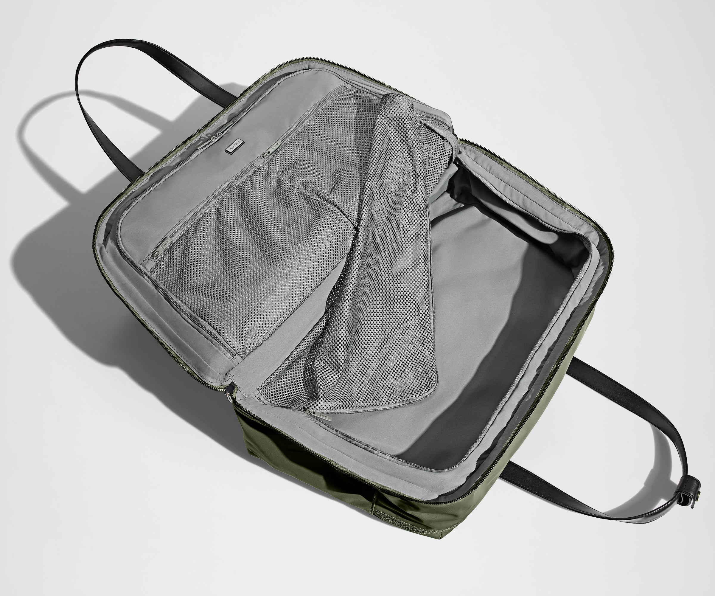 Green duffle bag with open front compartment on a white background