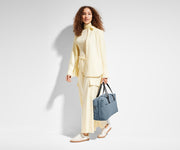 Person holding the Everywhere Bag by its leather straps