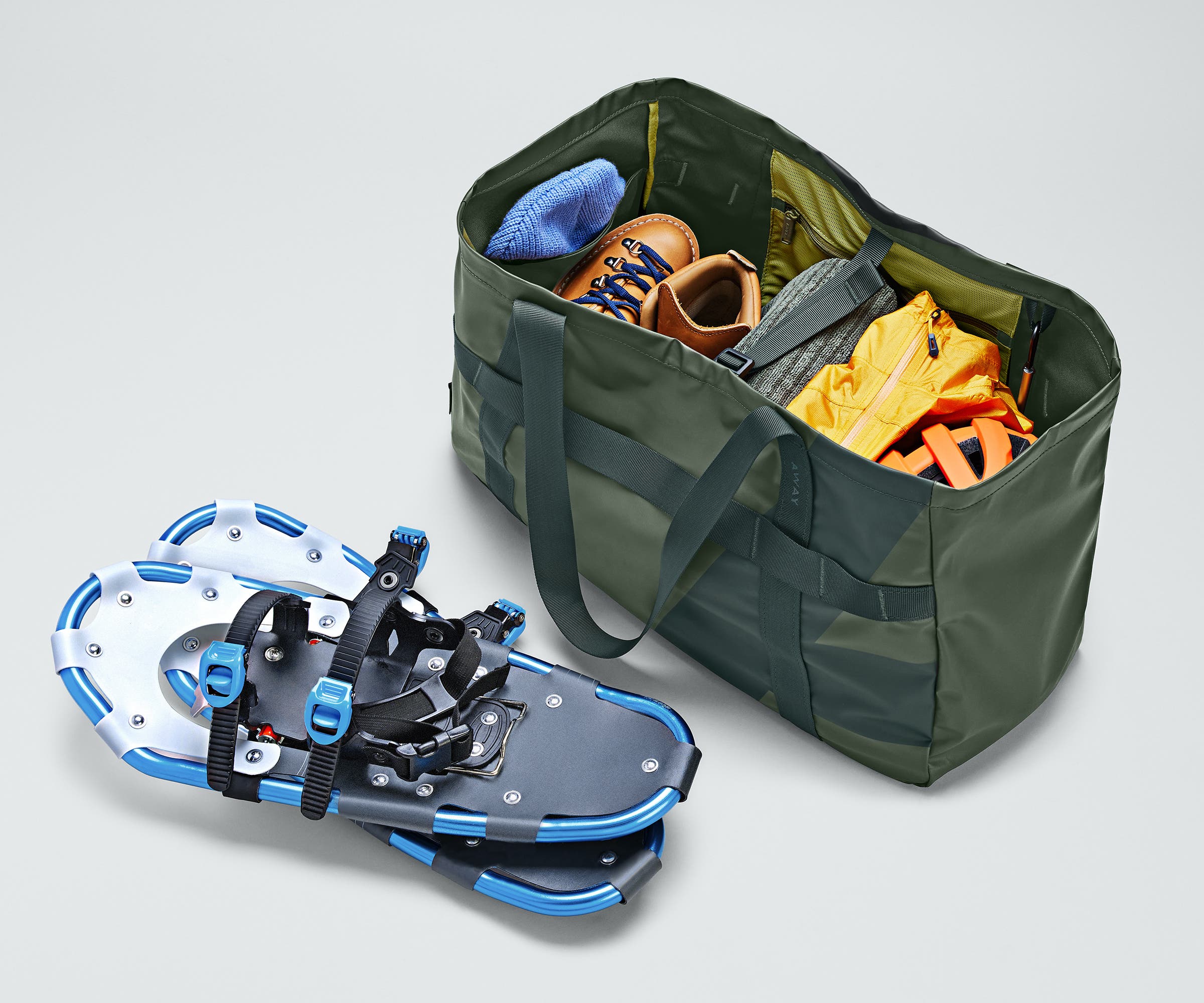 Active Tote 45L packed with clothing, hiking boots, helmet, and other outdoor gear