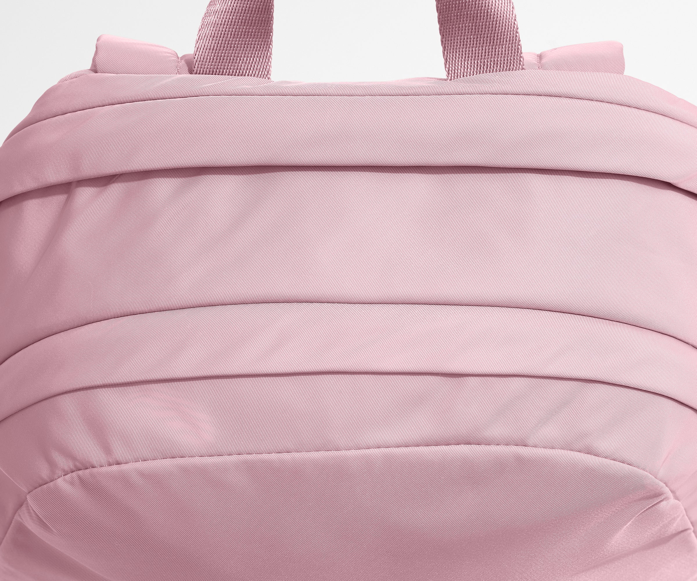 Close-up of a pink backpack with visible stitching details.