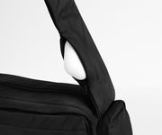 Earpods packed in the discreet, zippered strap pocket