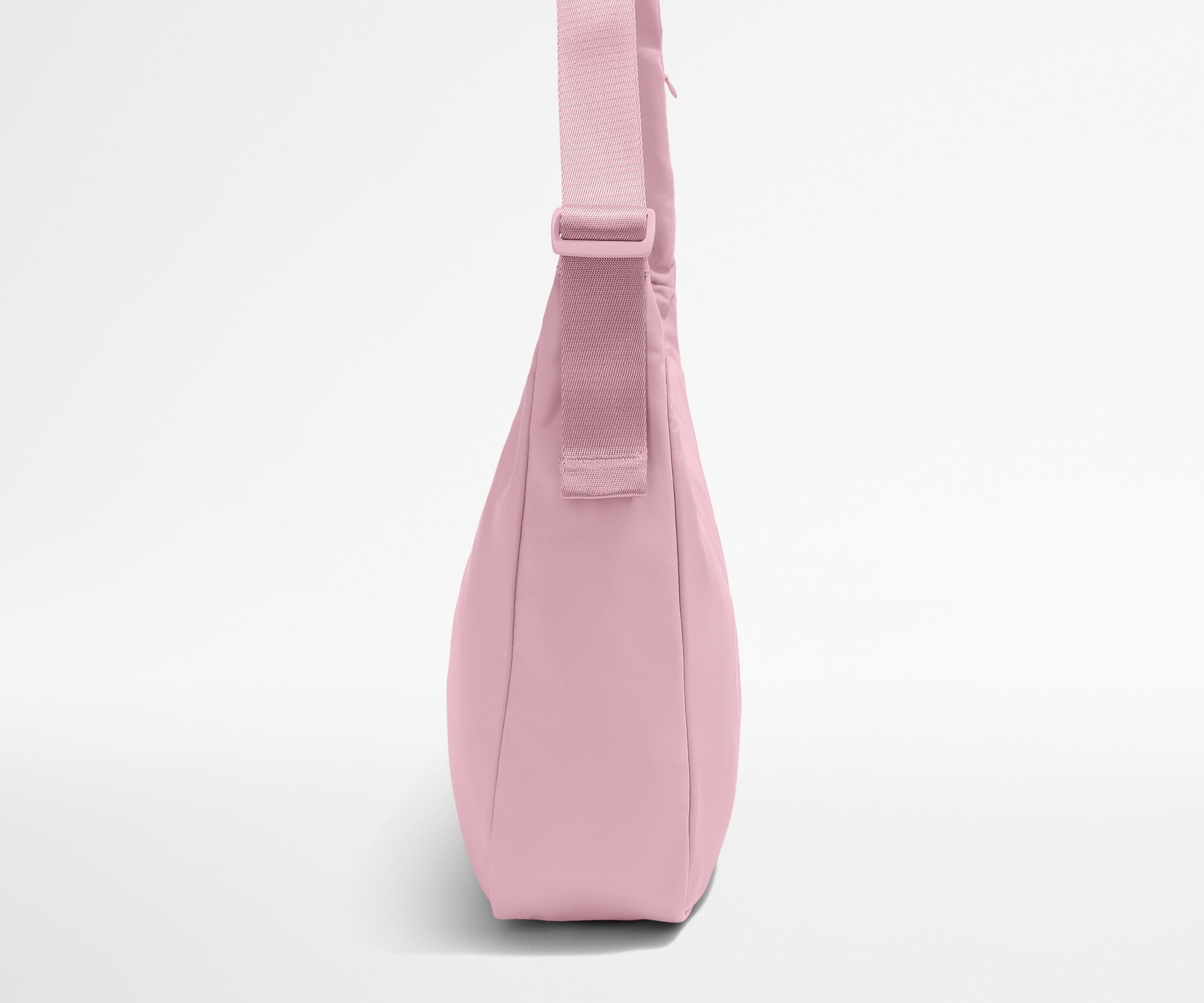 Pink crossbody bag on a light gray background