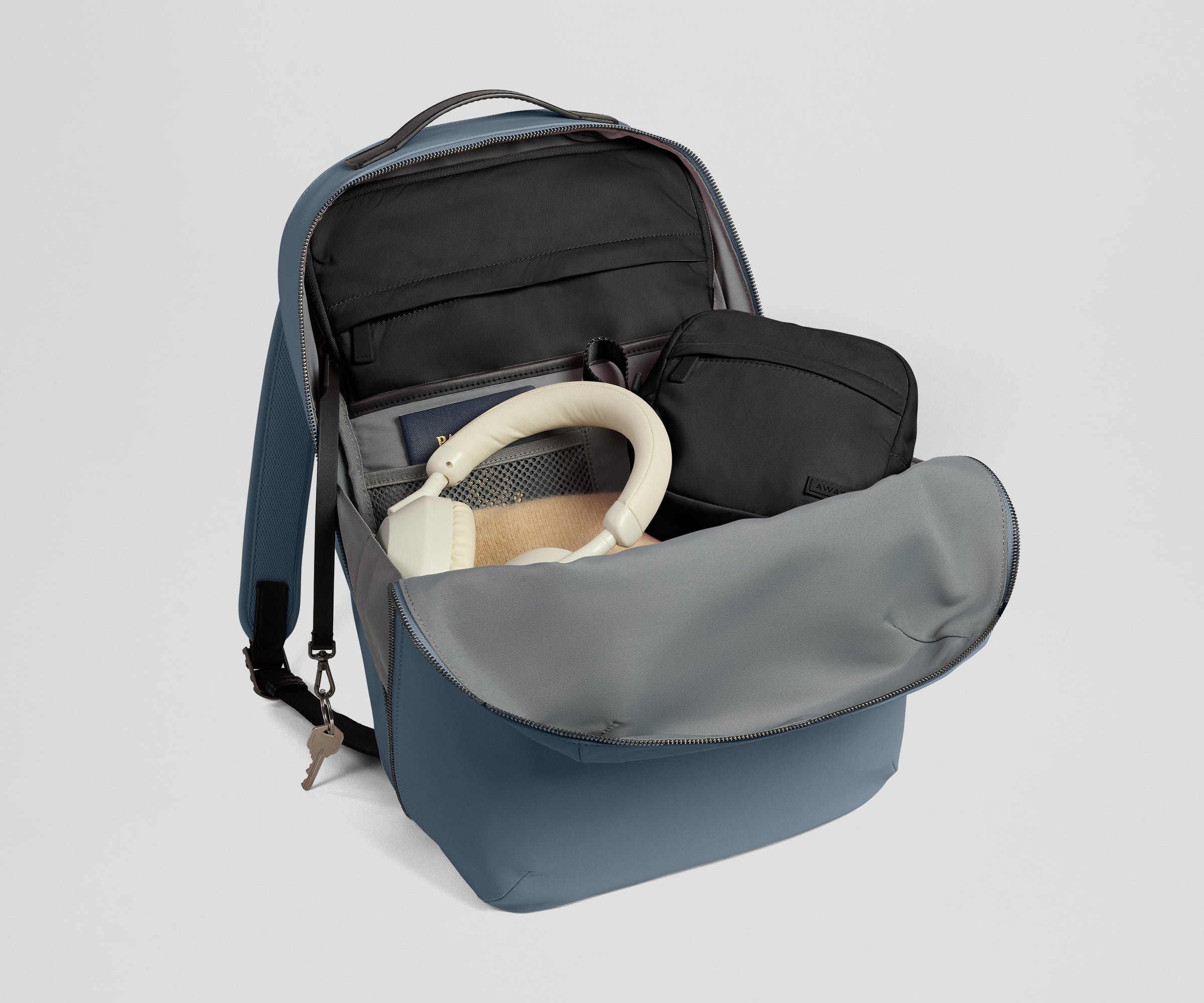 Backpack packed with a Black laptop sleeve and tech organizer