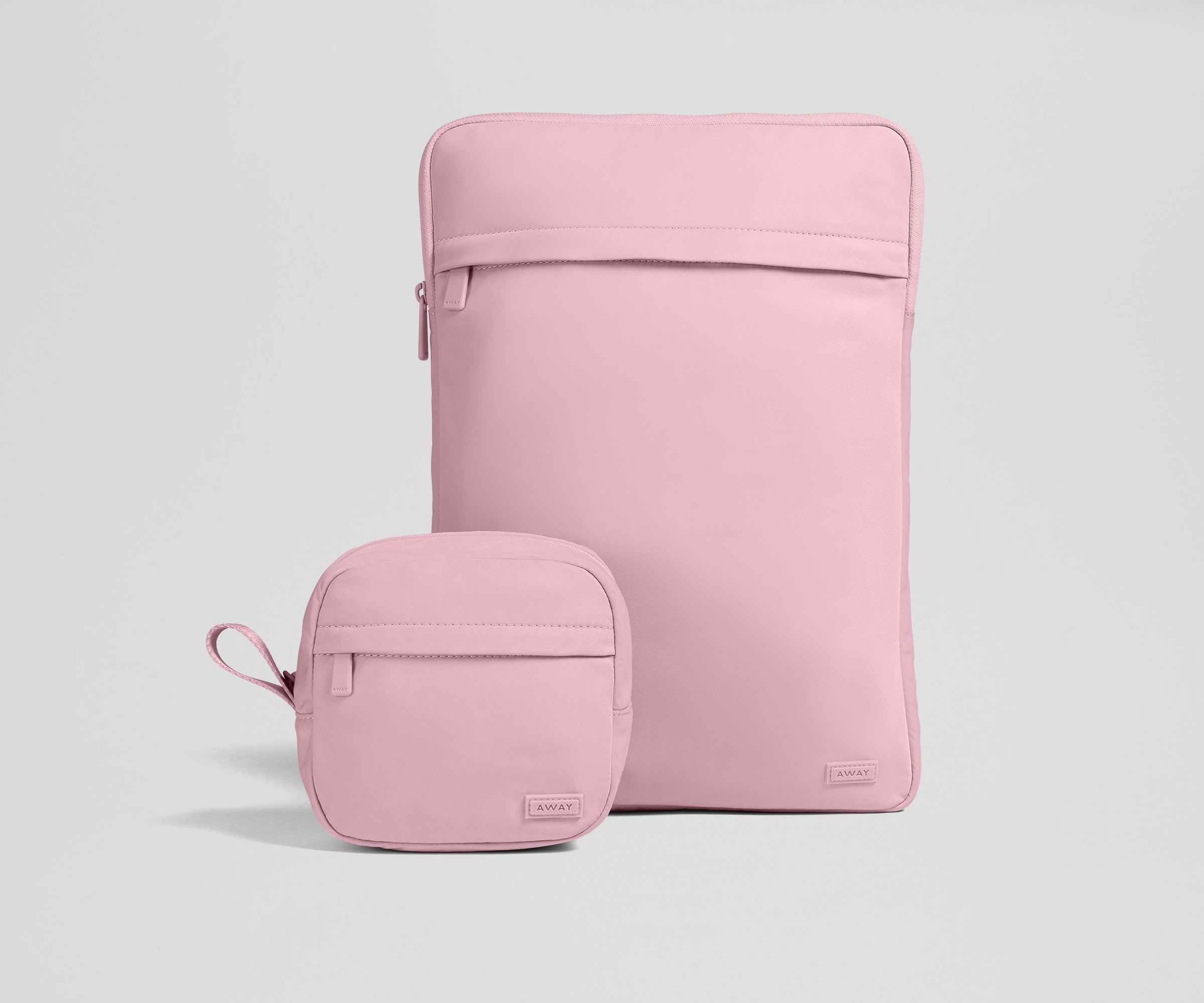 Pink laptop sleeve and matching pouch on a light gray background