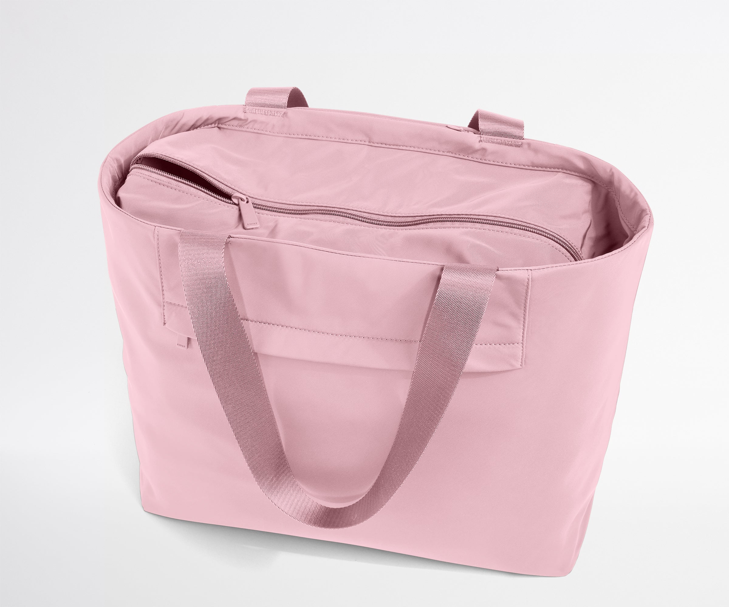 Pink tote bag with a zipper on a light gray background