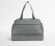 Gray duffel bag on a light gray background