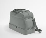 Gray duffel bag with a shoulder strap on a white background