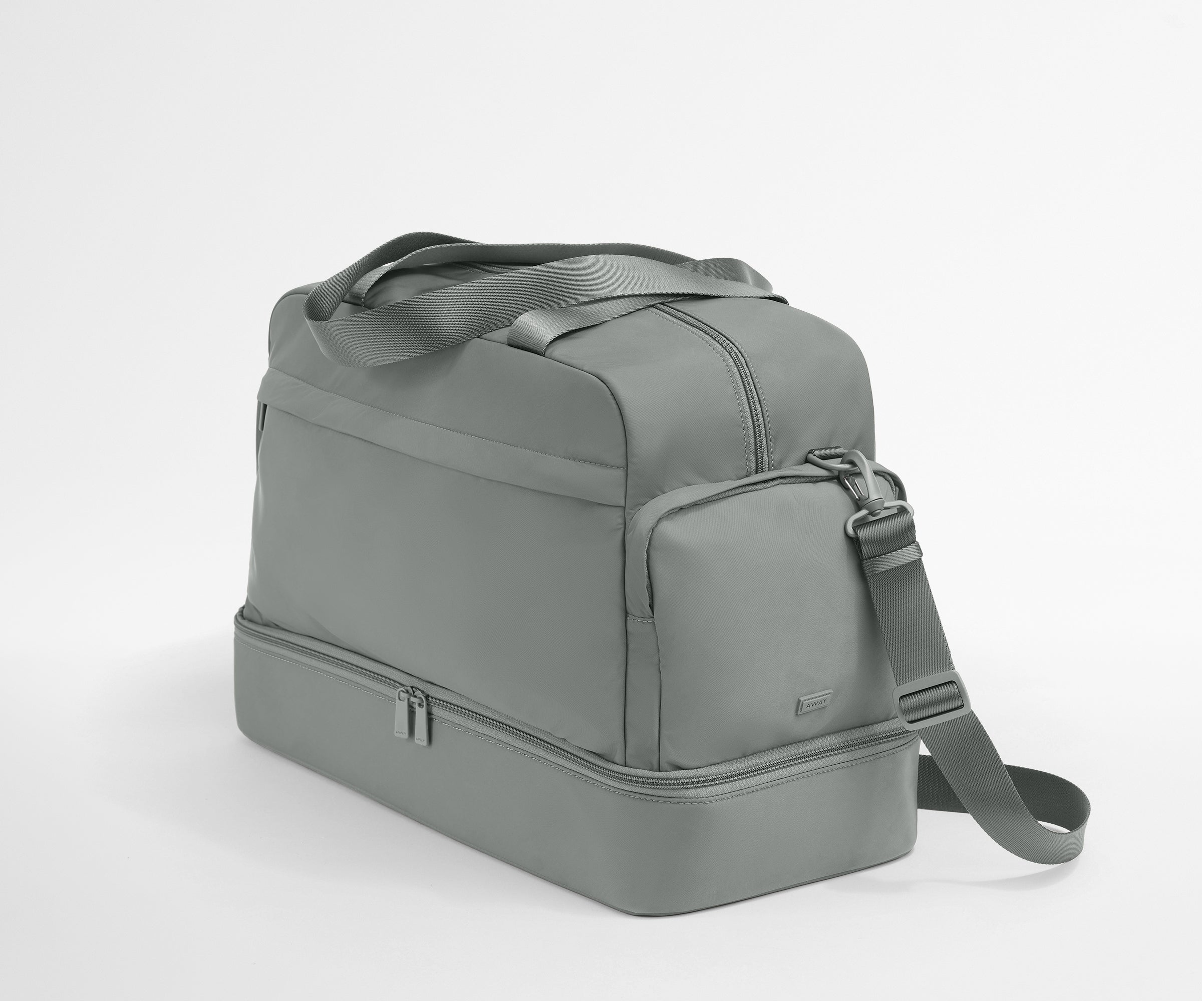 Gray duffel bag with a shoulder strap on a white background