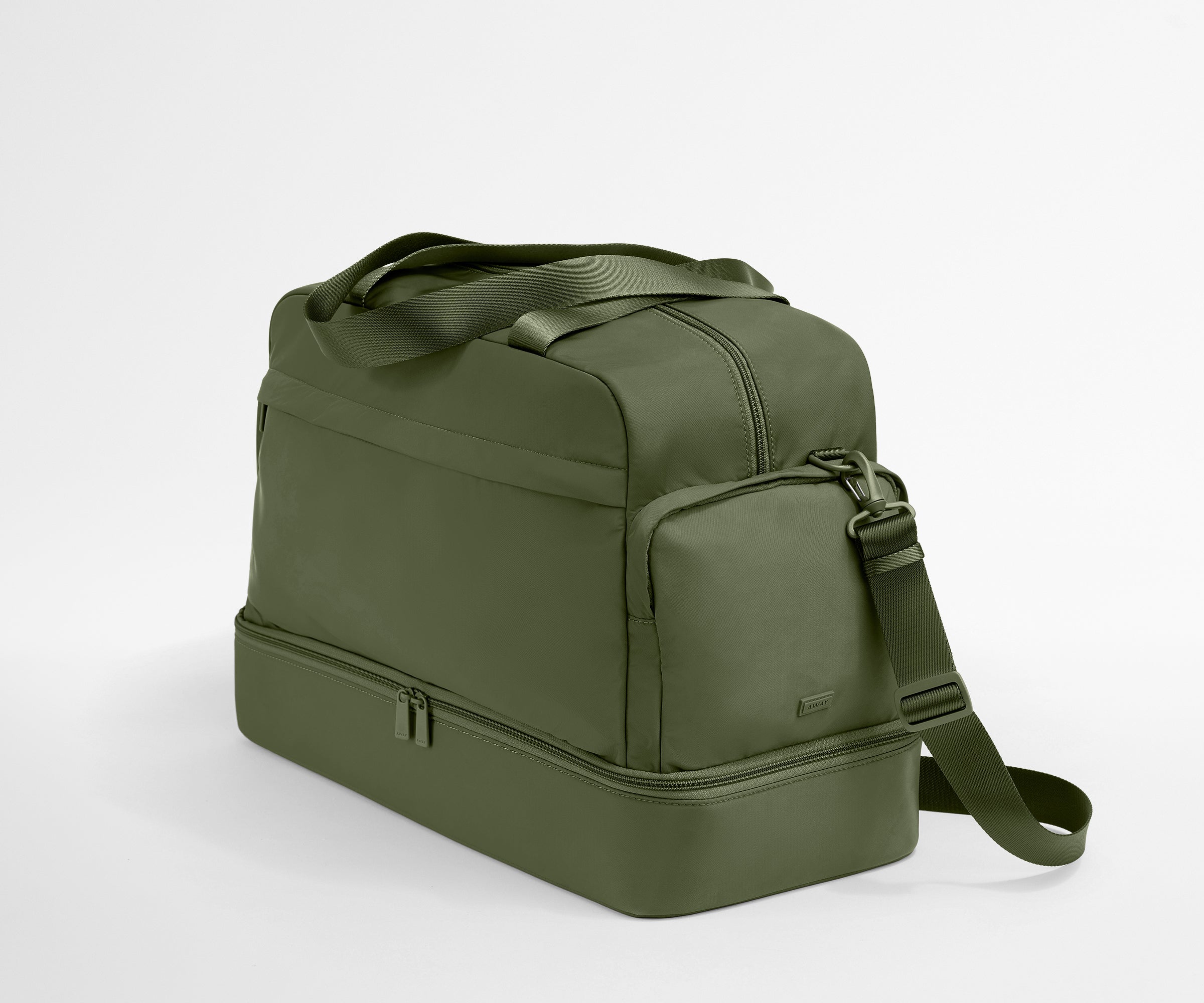 Green duffel bag with a shoulder strap on a light gray background
