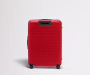 Red suitcase on a light gray background