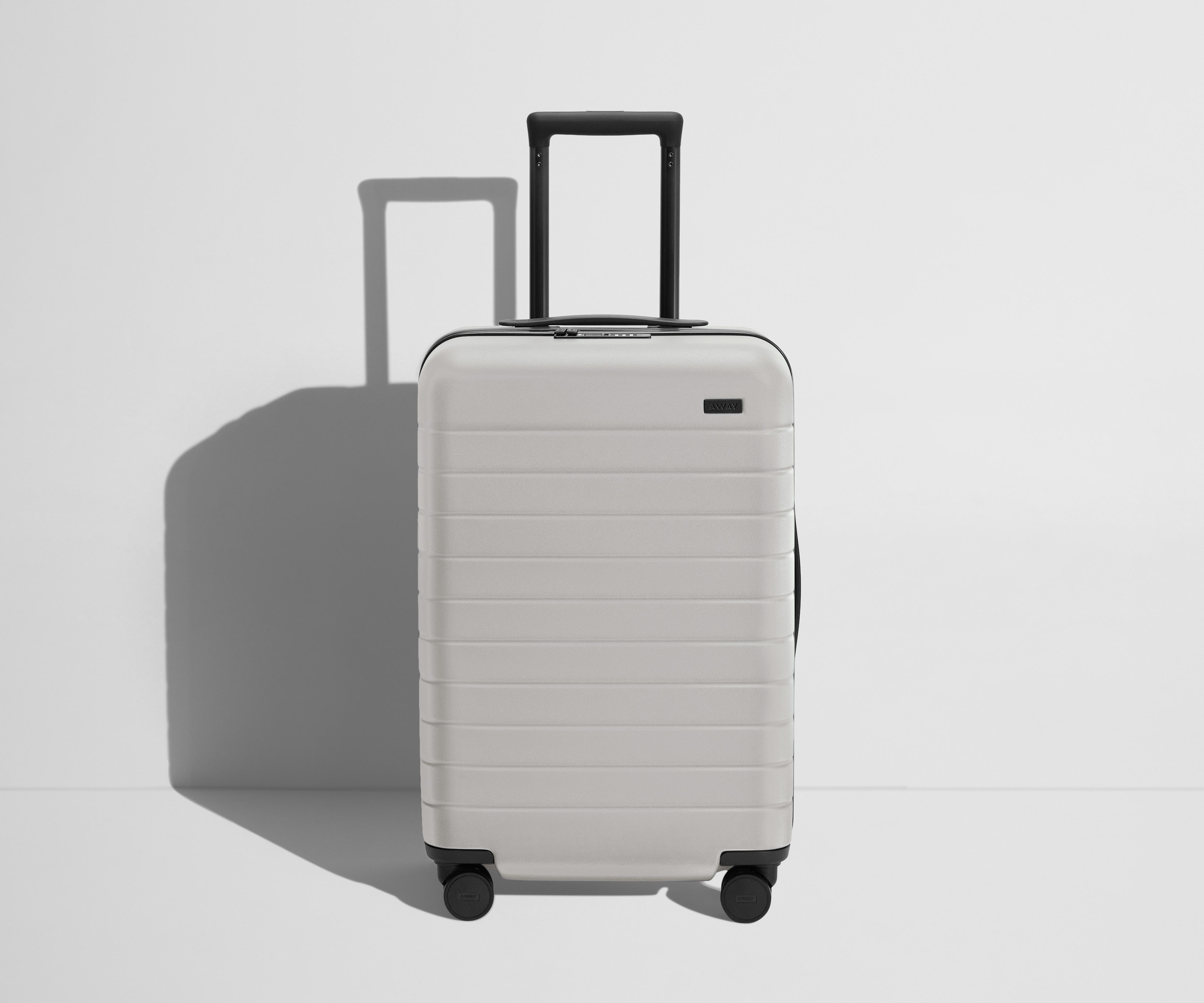 Front product view of The Bigger Carry-On Flex suitcase in Cloud Gray with raised handle