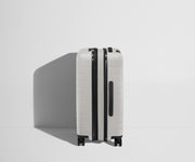 Side product view of The Bigger Carry-On Flex suitcase in Cloud Gray shown fully expanded