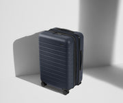 Angled product view of The Bigger Carry-On Flex suitcase in Navy Blue