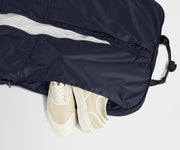 Showing one of two dedicated shoe pockets of the Garment Bag in Navy Blue