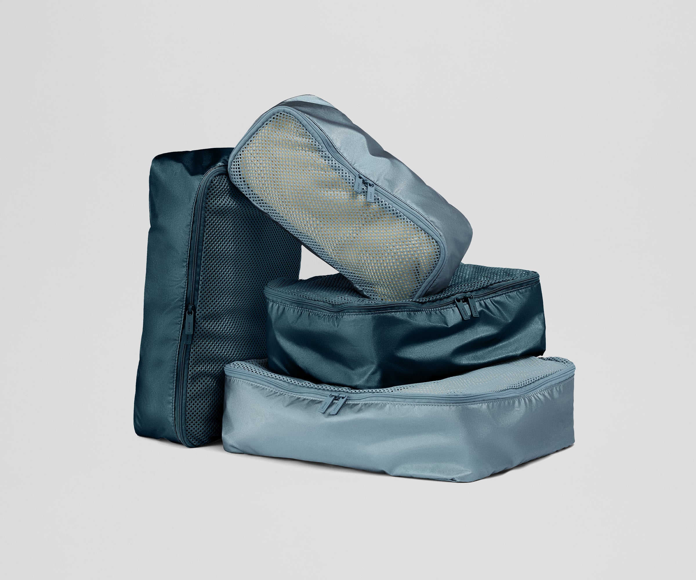 Set of blue packing cubes on a light gray background