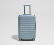 Blue suitcase on a light gray background