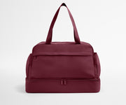 Maroon duffel bag on a light gray background
