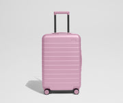 Pink suitcase on a light gray background