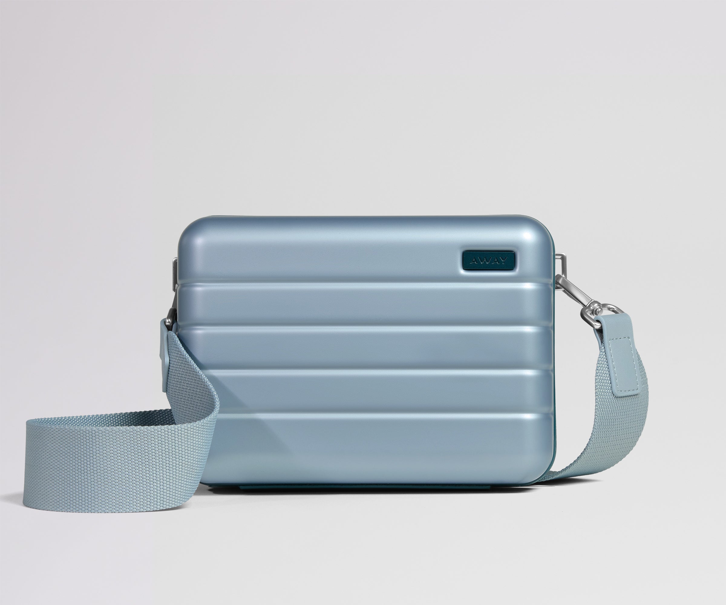 Light blue crossbody bag with a strap on a light gray background