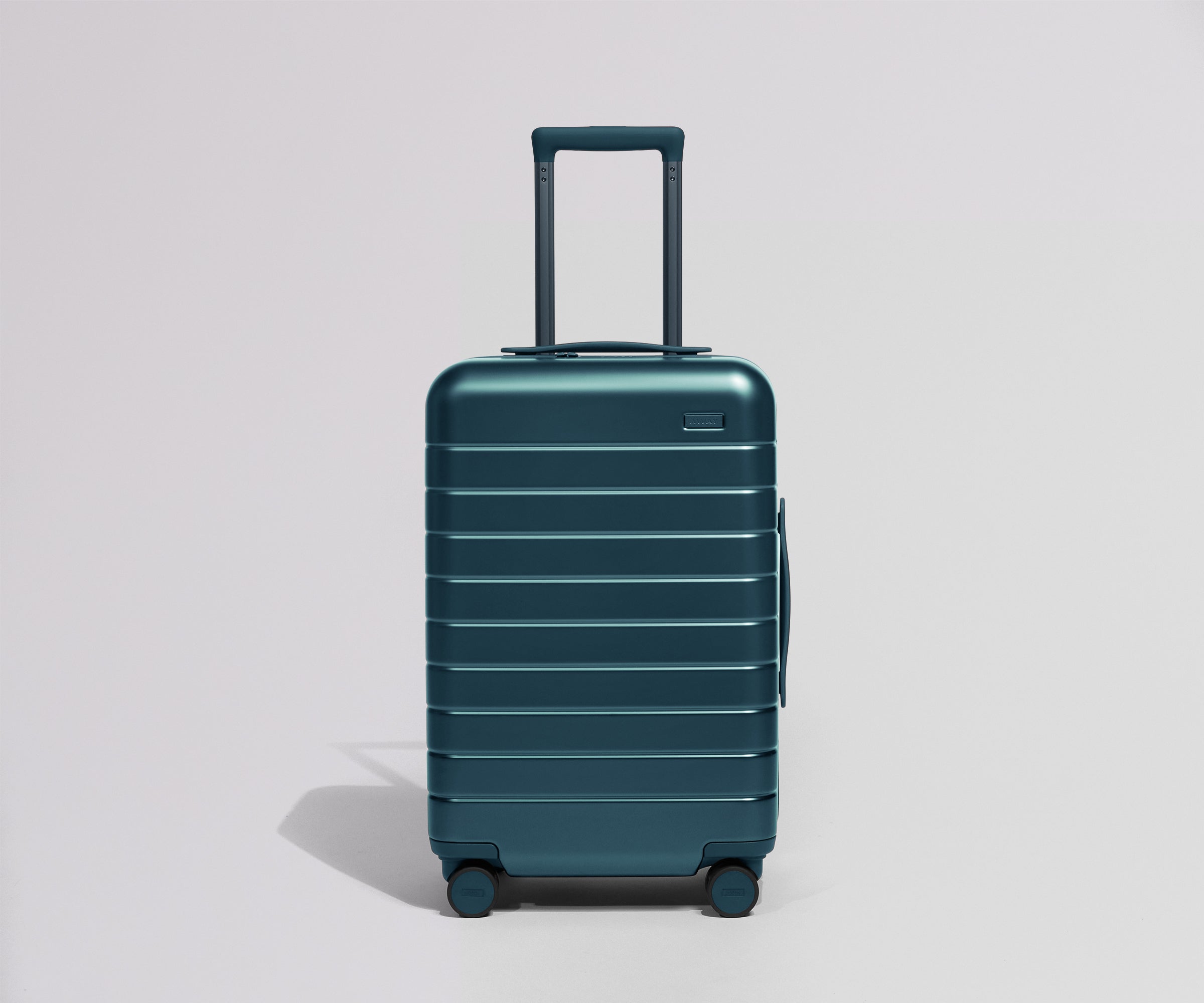 Teal suitcase on a light gray background