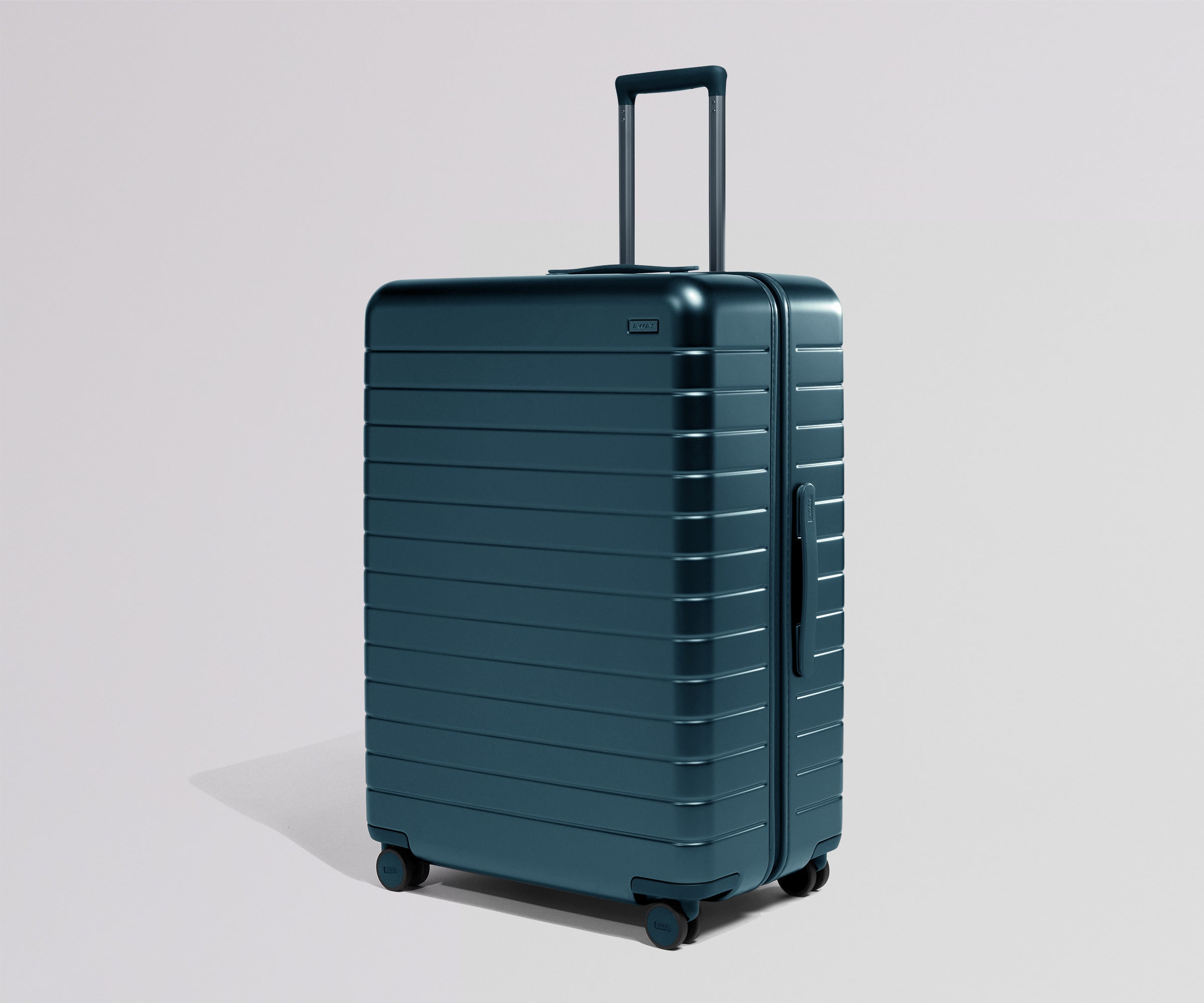 Teal suitcase with a matching handle on a light gray background