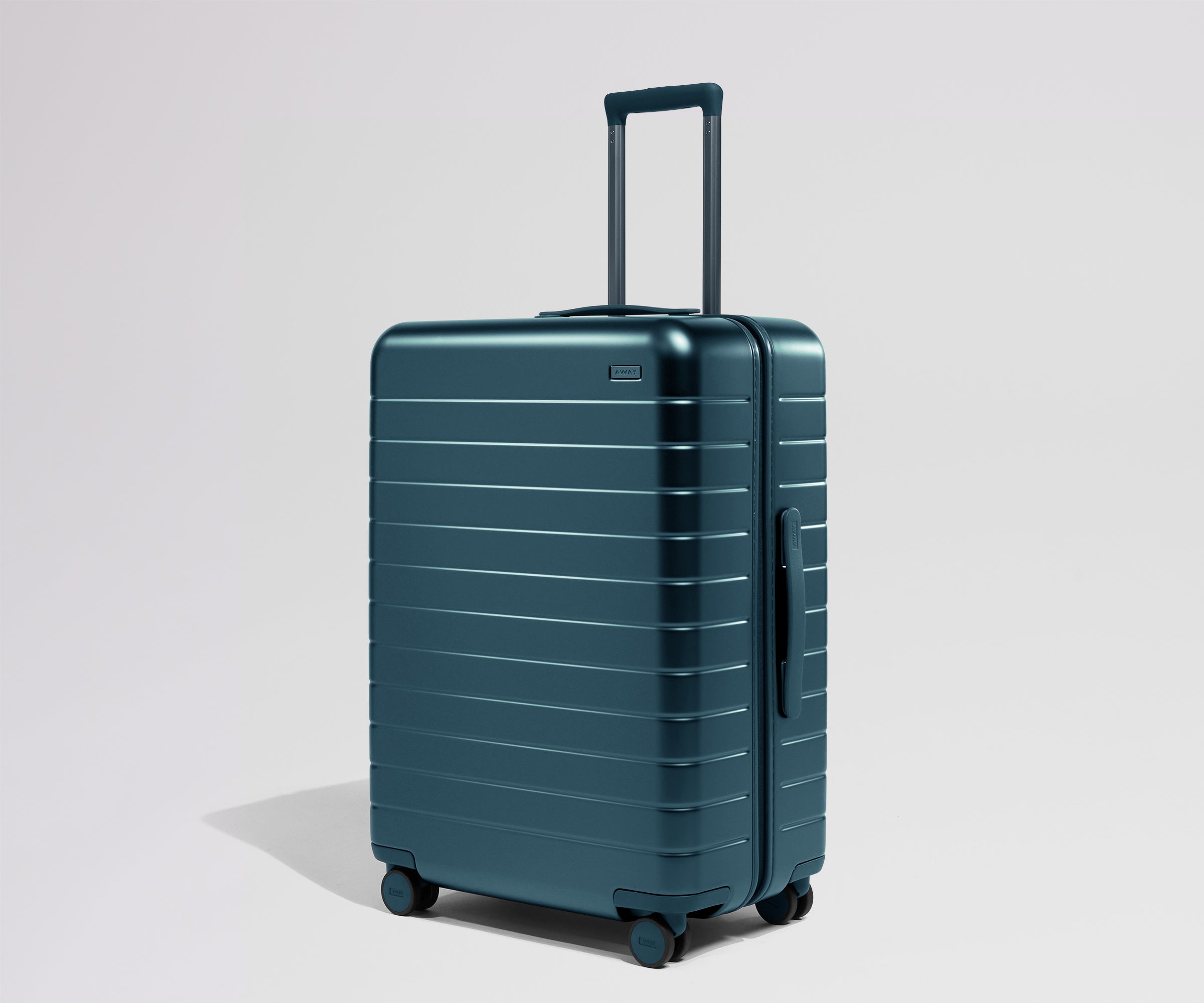 Teal suitcase with a handle on a light gray background