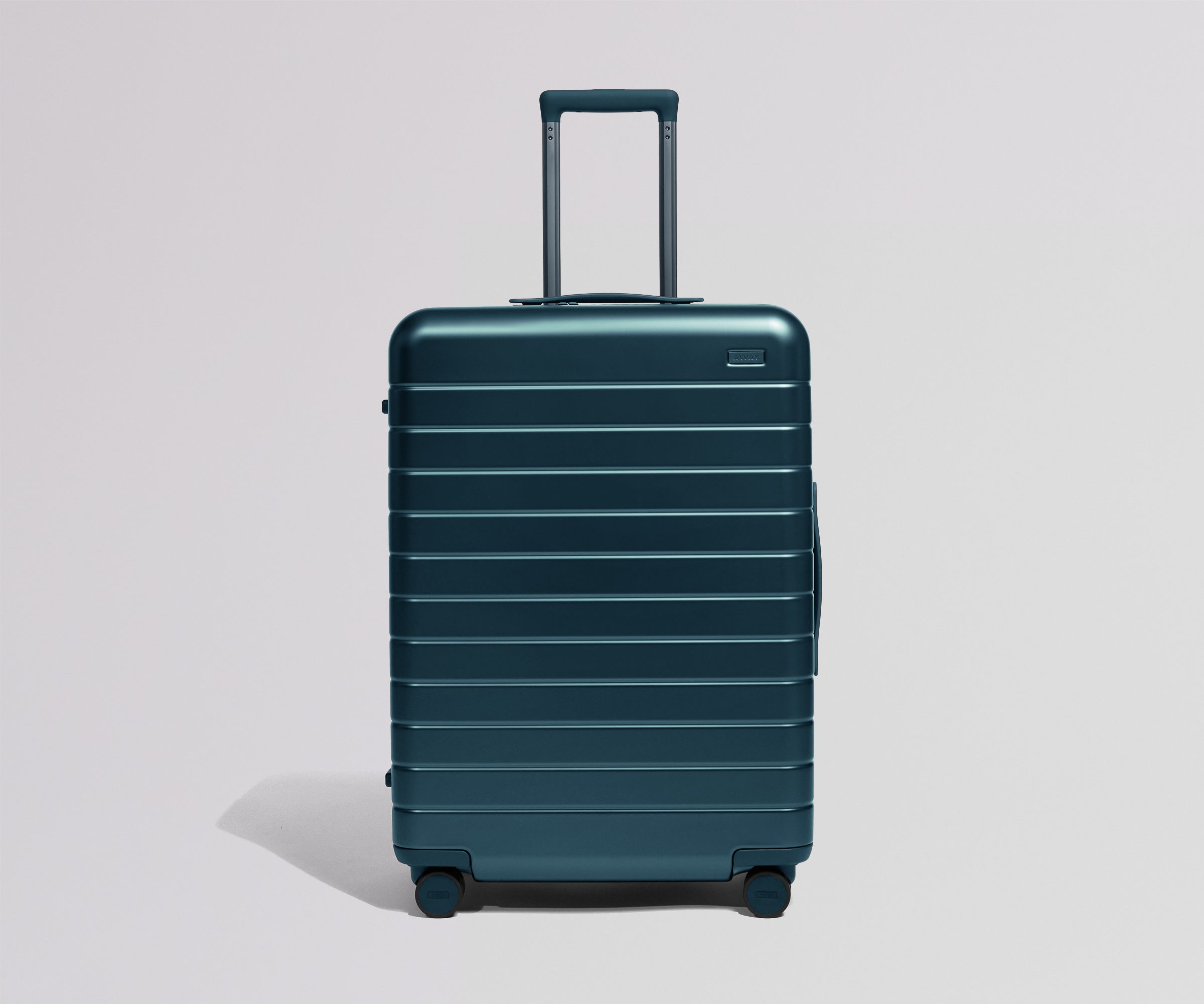 Teal suitcase on a light gray background