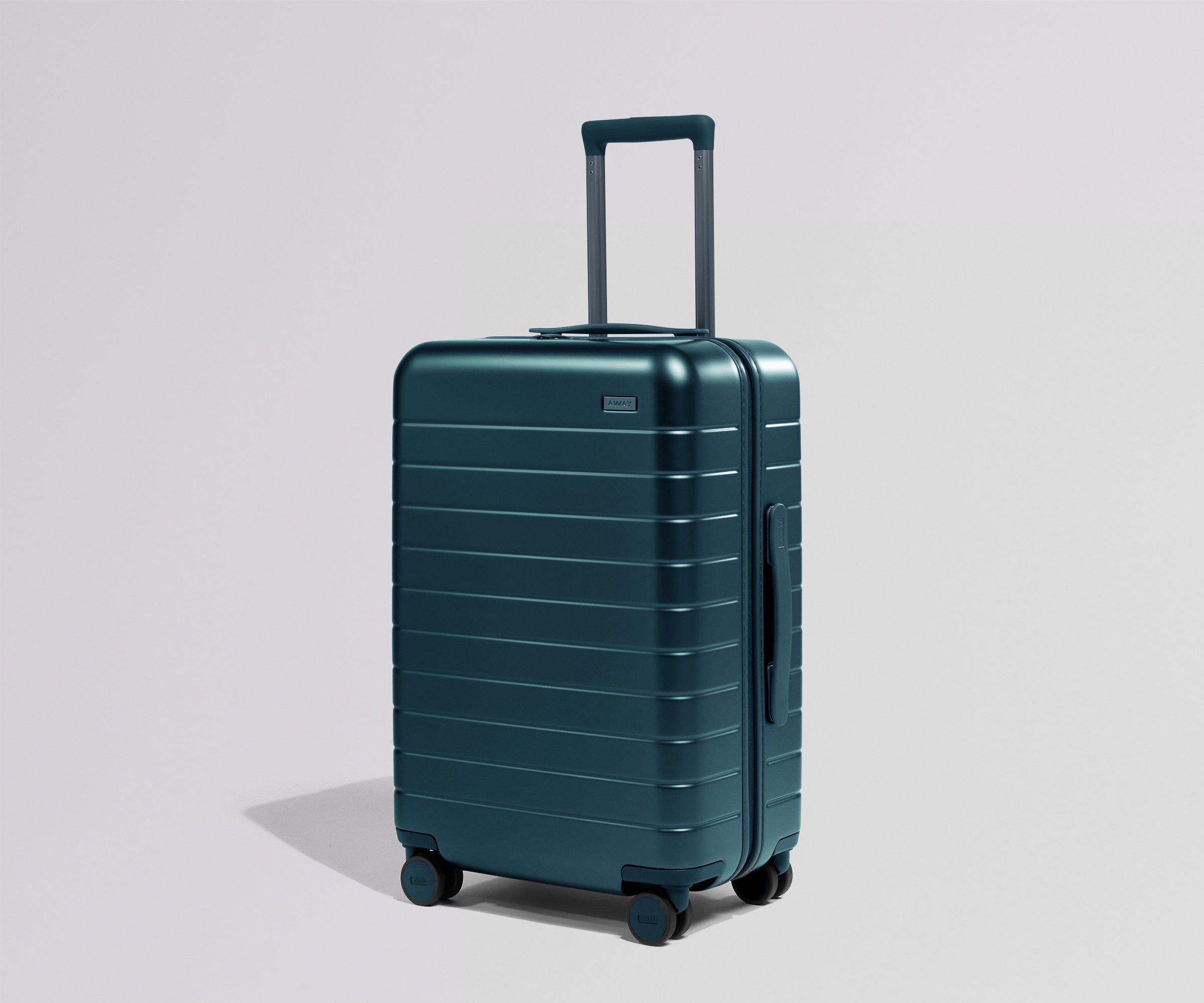 Teal suitcase on a light gray background