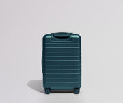 Back view of a teal suitcase on a light gray background