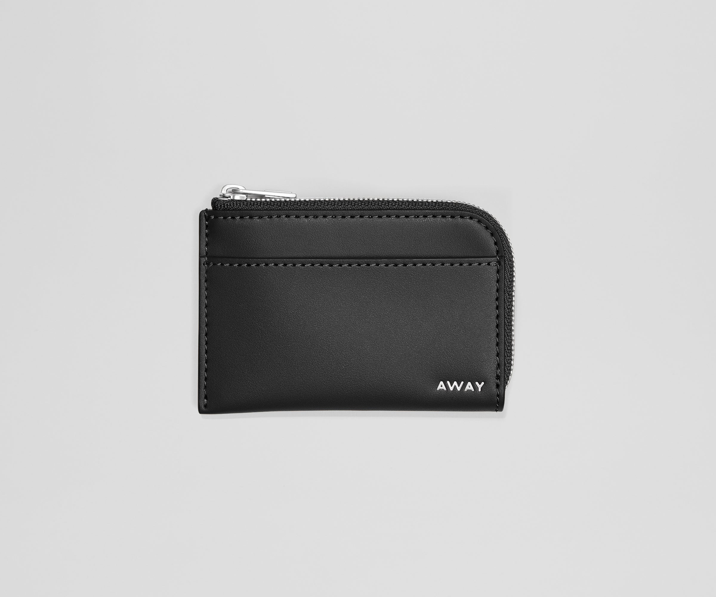 Black wallet with 'AWAY' branding on a light gray background