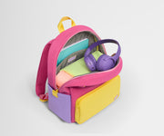Top down product view of the packed Kids Backpack in Cotton Candy Pink, showing how it fits clothes, tablet, notebook and headphones.