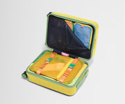 The Kids Carry-On suitcase in Sunshine Yellow shown open on its side and packed with Away's packing organizers to show capacity and the interior compression system, designed to help you pack more in