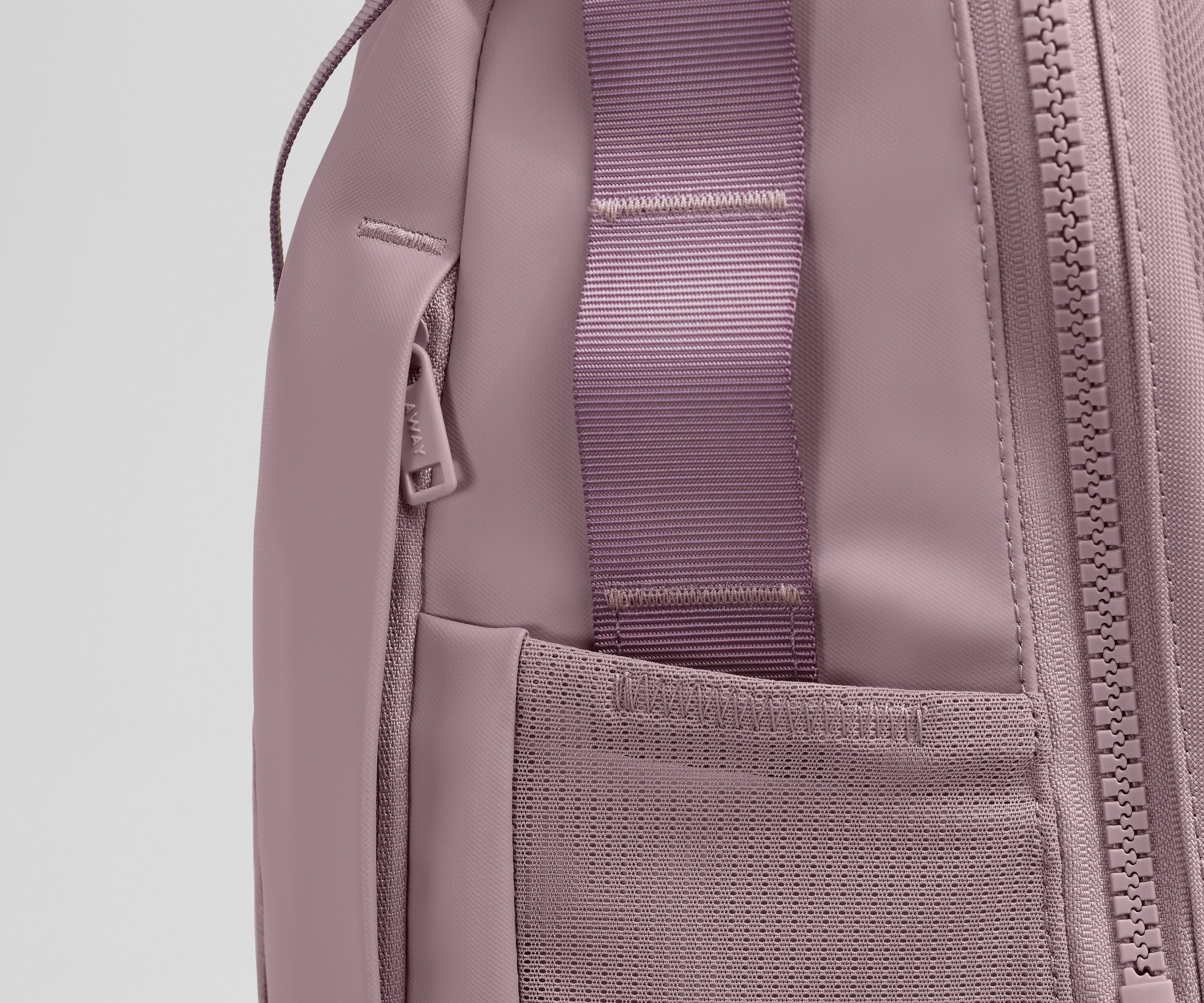 Close up view of the hidden zipper pocket, water bottle pocket, and side webbing loops