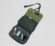 Hanging Toiletry Bag packed with nail care, a comb, and other toiletries like a toothbrush