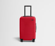 Red suitcase with a black handle on a light gray background
