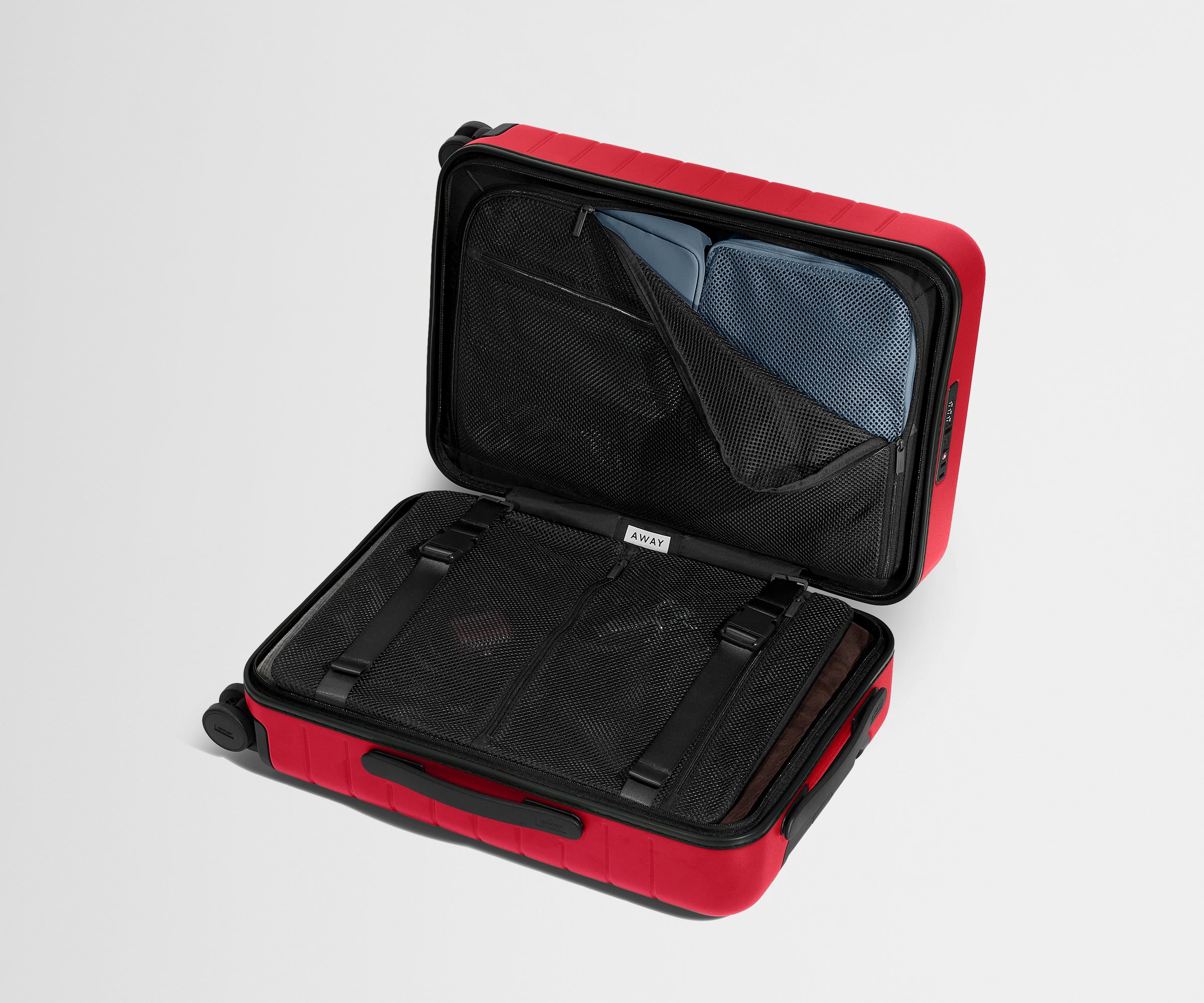Red suitcase with open compartment on a light gray background