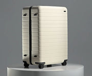 The Large suitcase in Salt White (Gloss) shown from below highlighting the underside grab handle