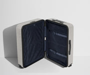 The Medium suitcase in Cloud Gray shown open in an upright position to show interior organization and compression system