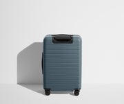 Back product view of The Bigger Carry-On Flex suitcase in Coast Blue