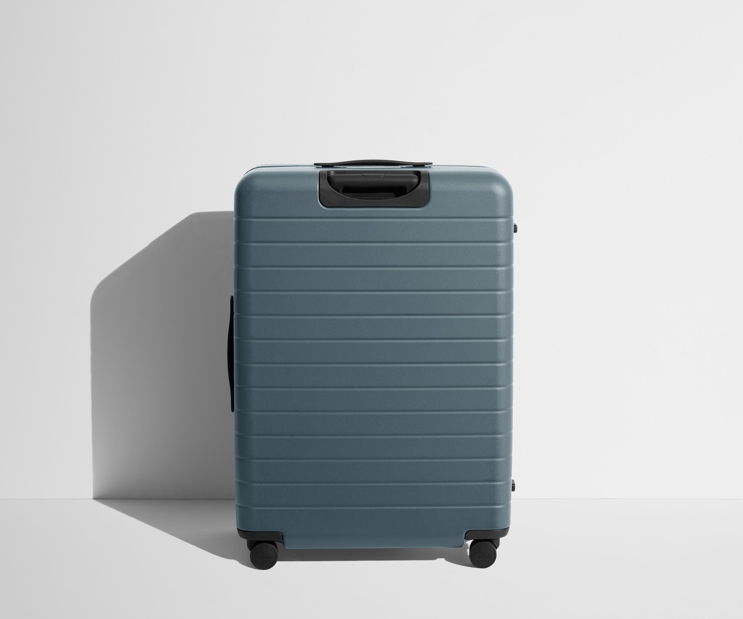Back product view of The Large Flex suitcase in Coast Blue