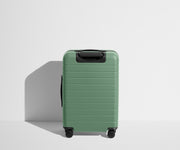 Back product view of The Bigger Carry-On Flex suitcase in Sea Green