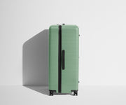 Side product view of The Trunk suitcase in Sea Green to show the slimmer top lid and deeper main compartment for easy access and packing
