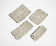 Set of four unpacked Packing Cubes laying flat