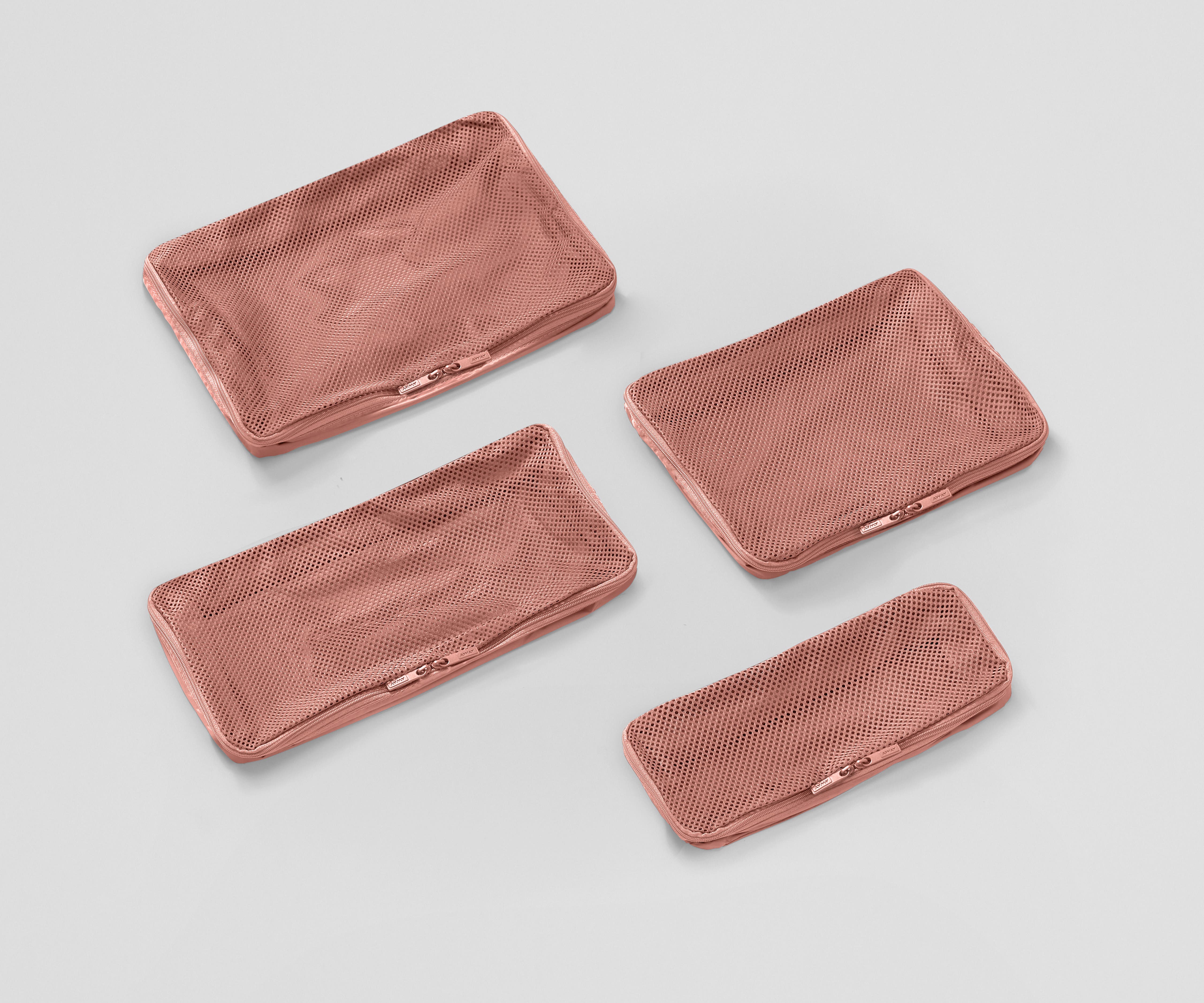 Set of four unpacked Packing Cubes laying flat