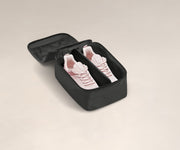 A pair of sneakers in a small Shoe Cube