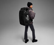 5'9" person wearing the 55L Boot Bag and winter clothes